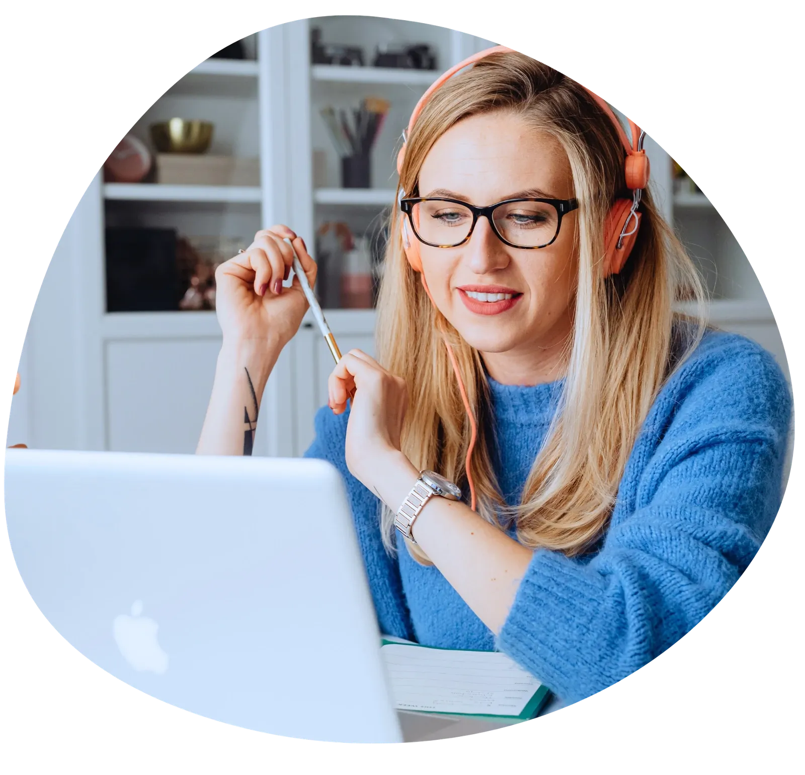 A woman with headphones taking an online course on her laptop
