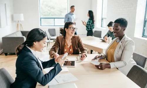 Accounting team reviewing financials together at a conference table
